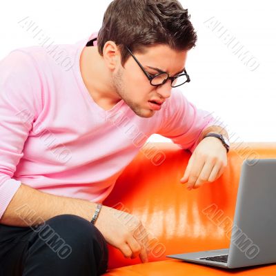 Closeup portrait of young man using laptop