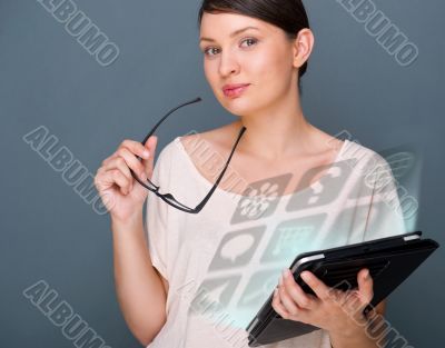 Portrait of young pretty woman holding tablet computer and glass