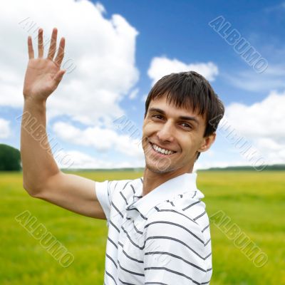 Portrait of young man taking energy from nature on vacation at c
