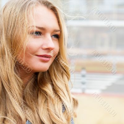 Closeup portrait of a beautiful woman in the city at summer time