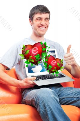 Portrait of young man thumbs up and showing display of his lapto