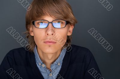 Portrait of young man with smart and wise look. Looking at camer