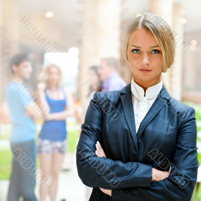 Portrait of a cute business woman with colleagues at the backgro