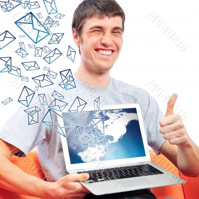 Portrait of handsome young man holding laptop computer and worki