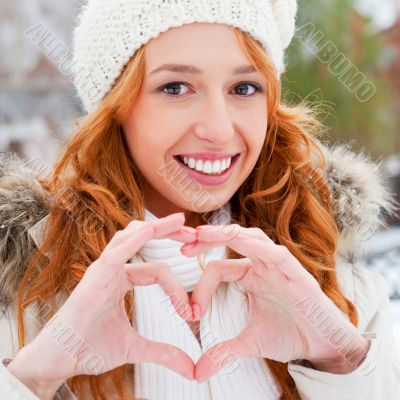 Portrait of beautiful young red hair woman outdoors in winter lo