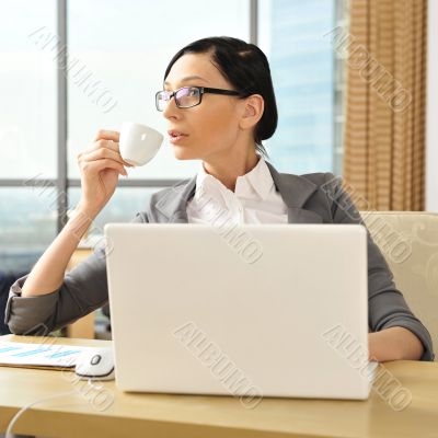 Portrait of a beautiful young businesswoman drinking water.