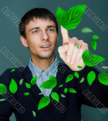 Portrait of young man sitting indoors at his office and working.