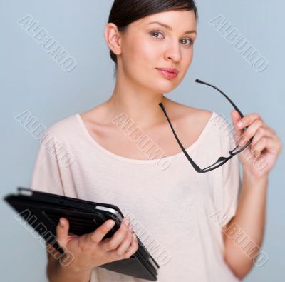 Portrait of young pretty woman holding tablet computer and glass