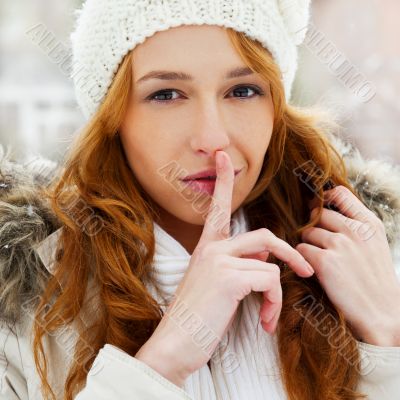 Portrait of young pretty woman in winter park