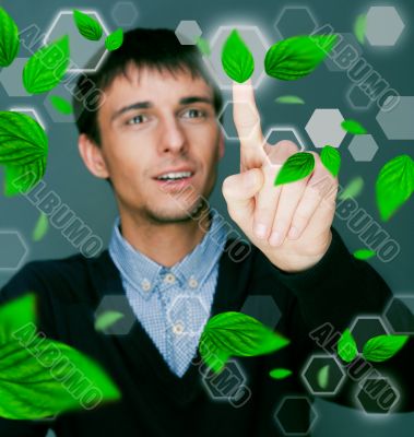 Portrait of young man sitting indoors at his office and working.