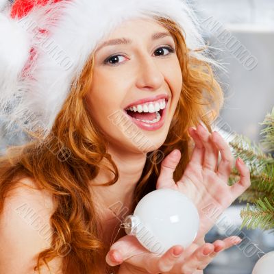 Christmas woman near a Christmas tree holding Christmas toy whil