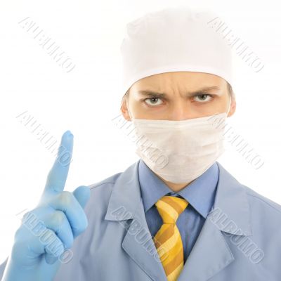 Closeup portrait of a serious young doctor pointing up