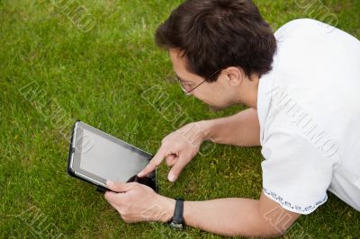 Man lying in the park at his backyard