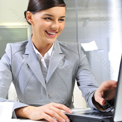 Young business woman on a laptop at her office