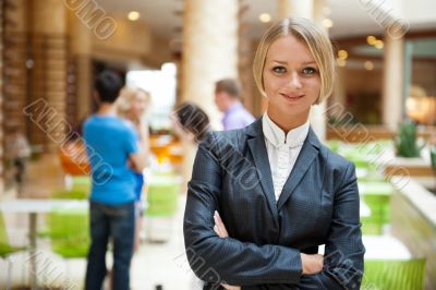 Portrait of a cute business woman with colleagues at the backgro