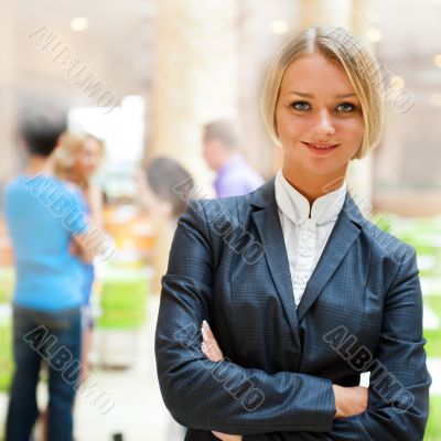 Portrait of a cute business woman with colleagues at the backgro