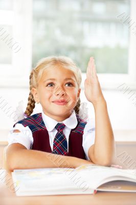 Image of smart child reading interesting book in classroom. Vert