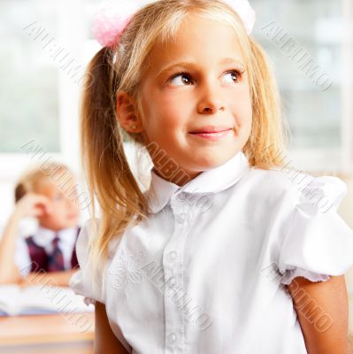 Portrait of a schoolgirl being in a classroom at school with her