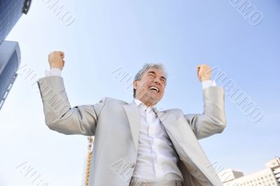 Portrait of a businessman with arms open.