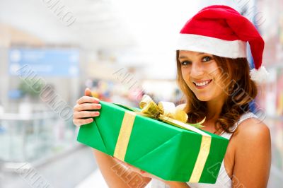 Portrait of young excited pretty woman standing inside shopping 