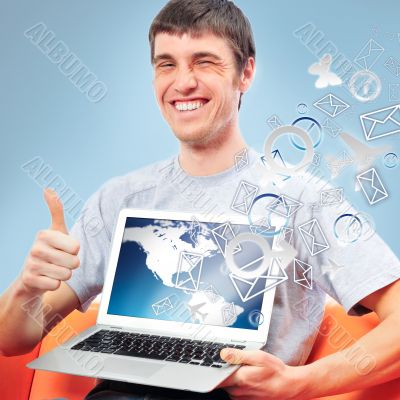 Closeup of a young smiling business man sitting at his home offi