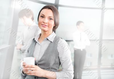 Portrait of a cute business woman with colleagues at the backgro