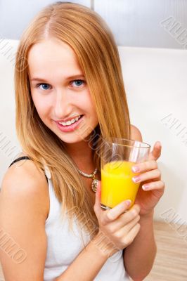 Portrait of beautiful relaxed young woman standing at the kitche