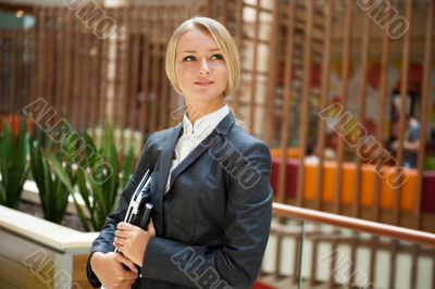 Portrait of a cute business woman with her laptop inside office 