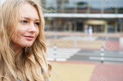 Closeup portrait of a beautiful woman in the city at summer time