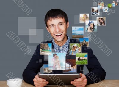 Portrait of young happy man sharing his photo and video files in