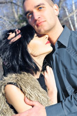 Young couple standig around in the nature - front view.