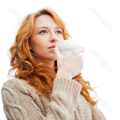 Portrait of beautiful red hair girl drinking coffee on winter ba