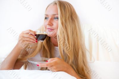 Closeup portrait of a pretty young female having a cup of coffee