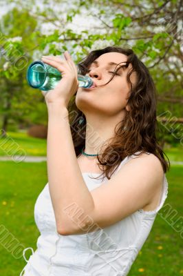 Young woman drinking water at outdoors