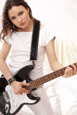 Portrait of young pretty girl who is feeling free and playing gu