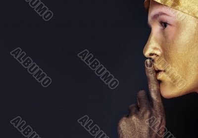 Portrait of young dancing girl with golden body art 