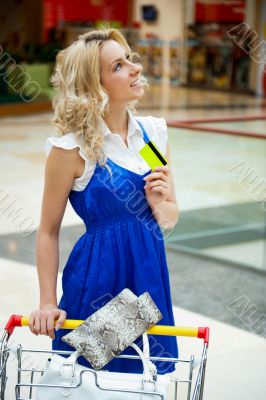 Photo of young joyful woman with shopping bags inside mall 
