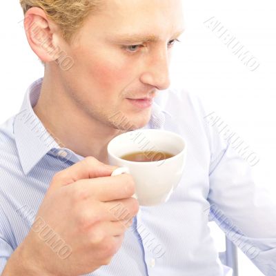 Successful business man is drinking a cup of coffee at his offic