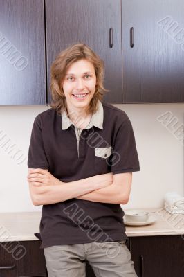 Happy young man after having a breakfast at home