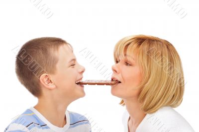 Portrait of happy european family of son and his mother eating c