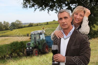 Couple drinking wine in a vineyard