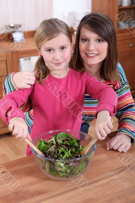 Mother and daughter making a salad together