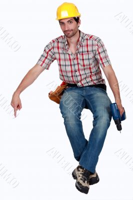 Man with a drill pointing down