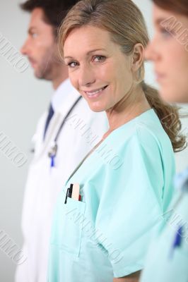 Three medical professionals standing in a line