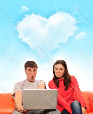 Portrait of a young couple using a computer