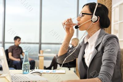 Portrait of a beautiful young businesswoman drinking water.
