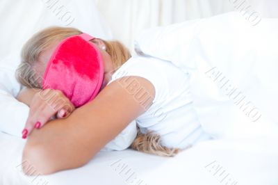 Closeup portrait of a cute young woman sleeping on the bed weari