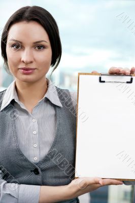 Portrait of business woman holding blank reports and looking at 