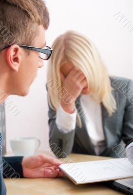 Young tired business people are working in the office.