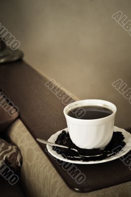 warm cup of coffee on brown background